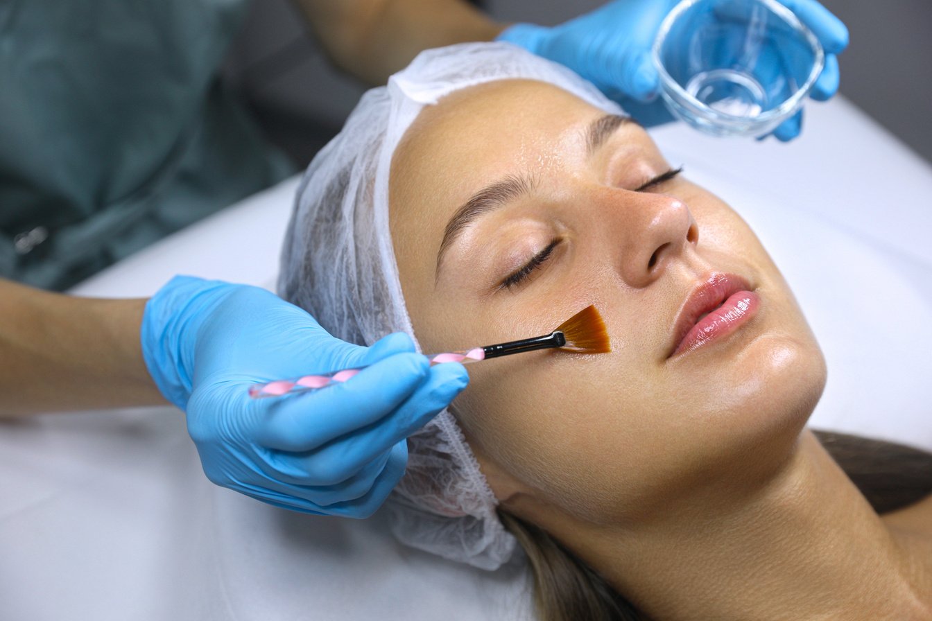 Cosmetologist Applying Chemical Peel Product on Client's Face in